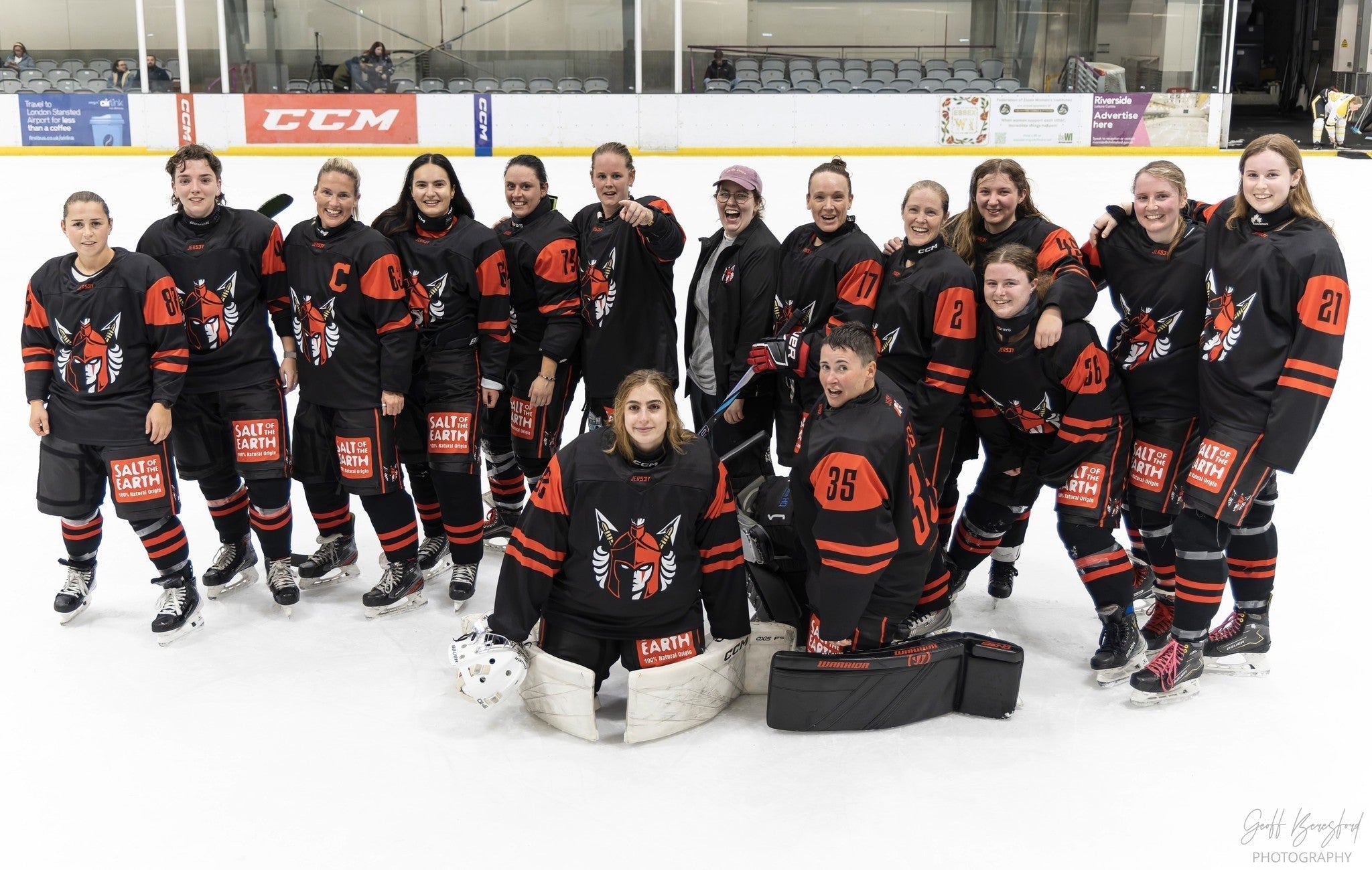 Salt of the Earth sponsored Solent Amazons women’s ice hockey team posing on the rink in black and red uniforms with visible Salt of the Earth branding, celebrating their UK partnership